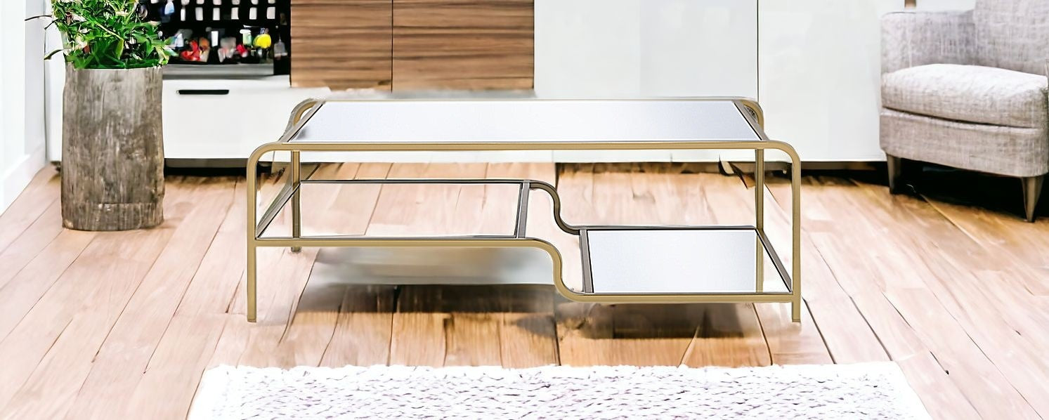 52" Clear and Gold Mirrored Glass And Iron Coffee Table With Shelf - Loft&Timber